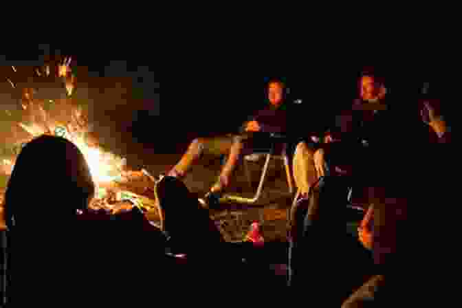 A Group Of People Gathered Around A Campfire, Their Faces Illuminated By The Flickering Flames, Symbolizing The Transformative Power Of Embracing Darkness. The Colour Of Darkness