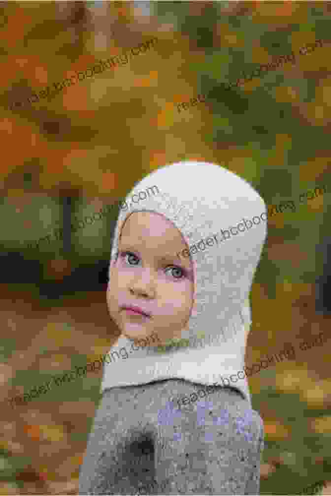 Adorable Child Wearing A Hand Knitted Childs Balaclava From Knitting Pattern Kp306, Showcasing Its Cozy And Protective Design. Knitting Pattern KP306 Childs Balaclava Knitting Pattern 6 12mths 1 2yrs 3 4yrs 4 6yrs DK